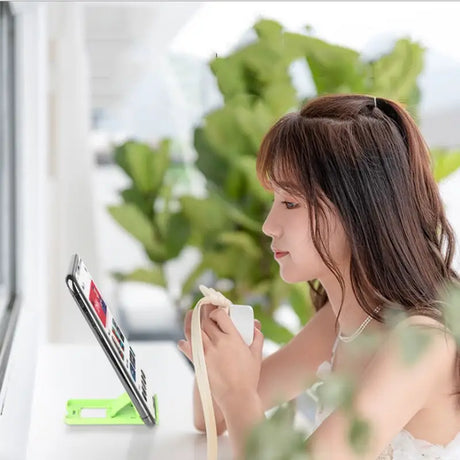 a woman sitting at a desk with a tablet