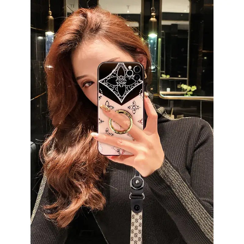 woman taking a selfie with her cell phone in a mirror