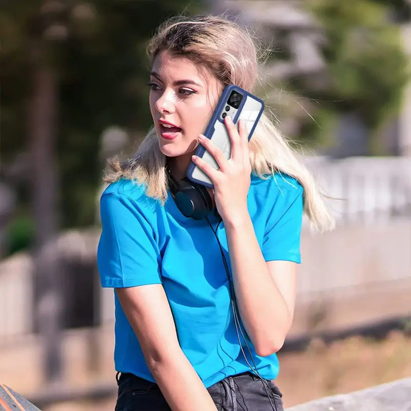 a woman talking on her cell phone while sitting on a bench