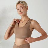 a woman in a tan sports bra top and matching shorts