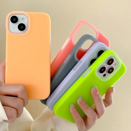 A woman holding three different colored cases