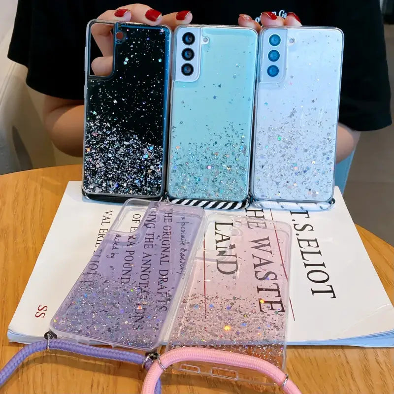 a woman holding up three iphone cases