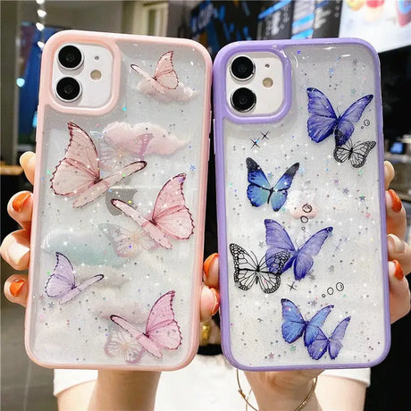 a woman holding two cases with butterflies on them