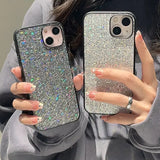 a woman holding two iphone cases with silver glitter