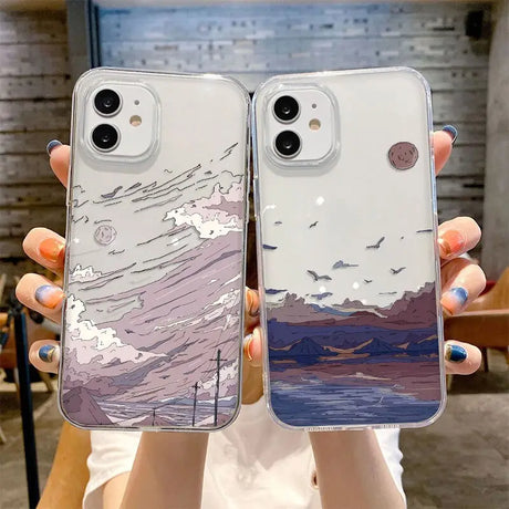 A woman holding two iphone cases with a painting on them