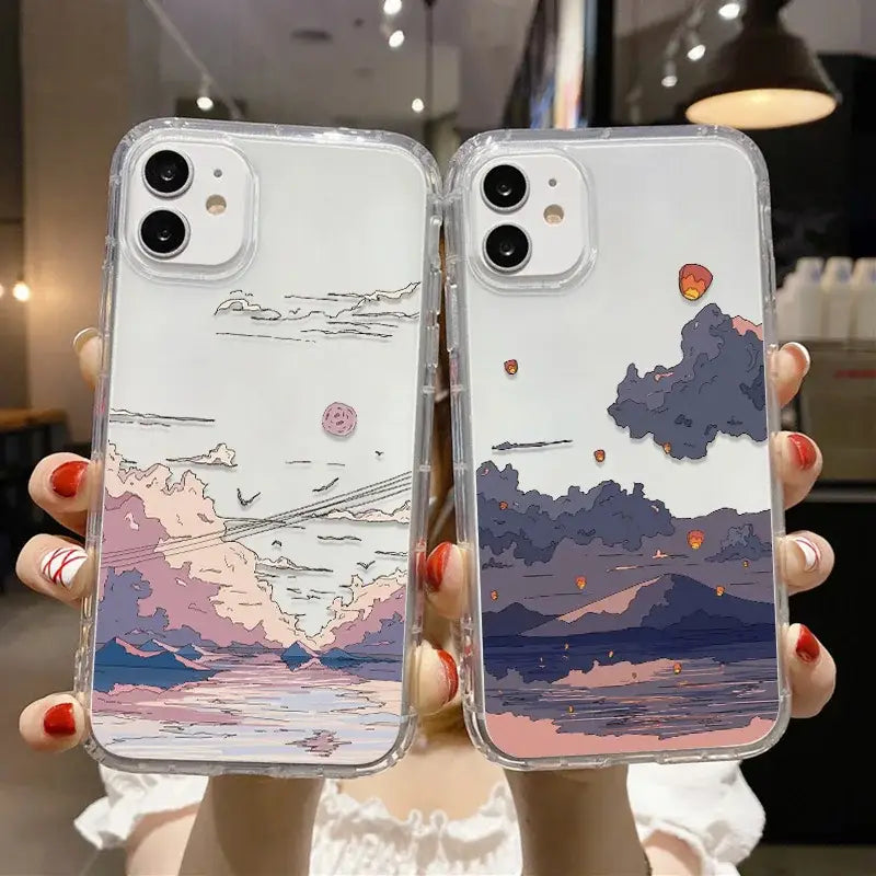 A woman holding up two iphone cases with a painting of clouds