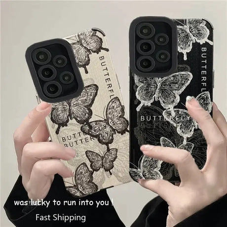 a woman holding up two iphone cases