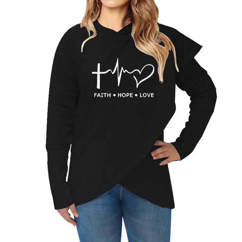 a woman wearing a black hoodie with the word faith and hope in white