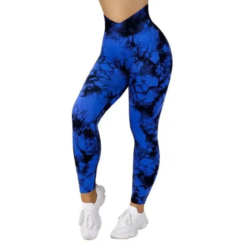 a woman wearing blue and black tie dye leggings