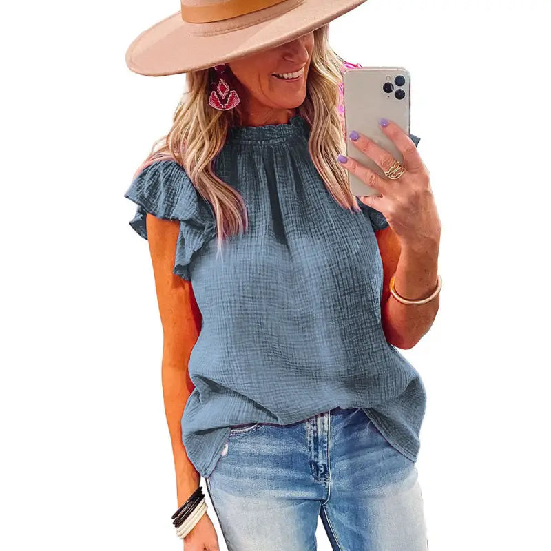 a woman wearing a hat and jeans