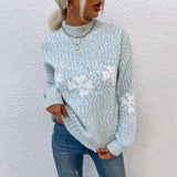 a woman wearing a blue sweater and jeans