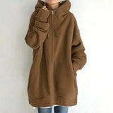 a woman wearing a brown hoodie jacket