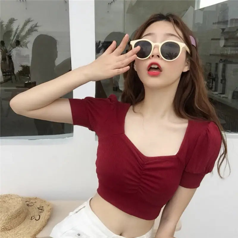 a woman wearing sunglasses and a red top