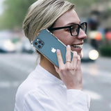 a woman with glasses talking on her cell