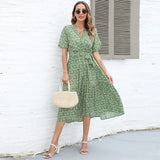 a woman wearing a green floral dress