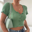 a woman wearing a green top and jeans