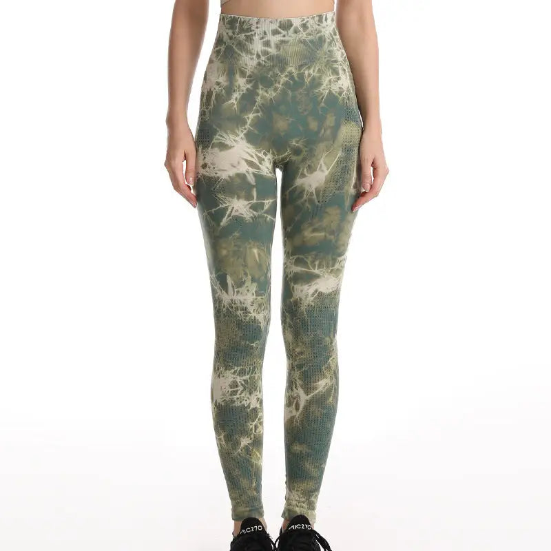 a woman wearing a green and white tie dye leggings