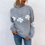 a woman wearing a grey sweater with a white unicorn on it