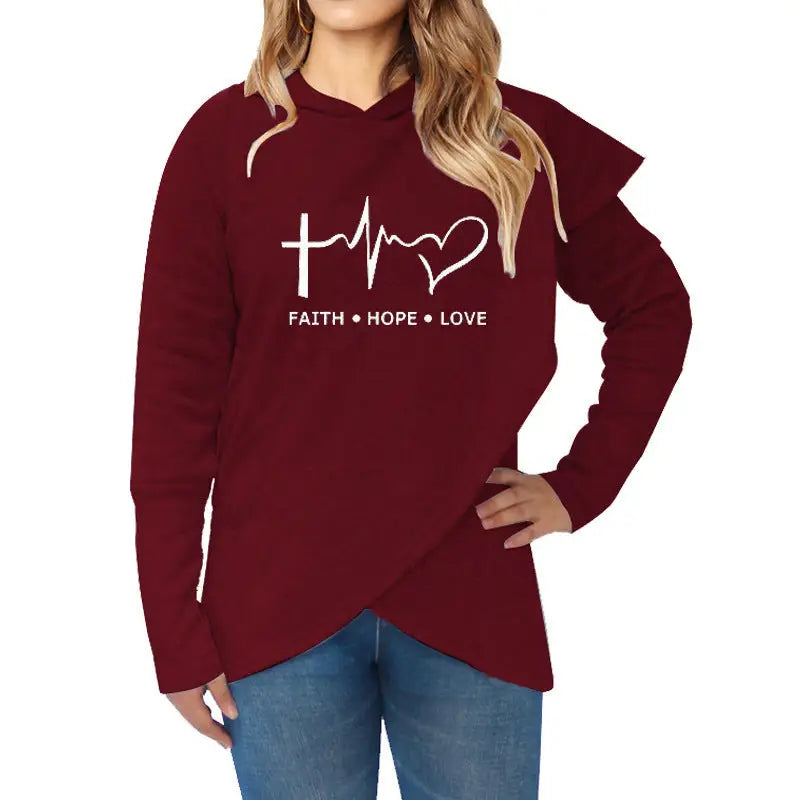 a woman wearing a maroon hoodie with the word faith and a heart