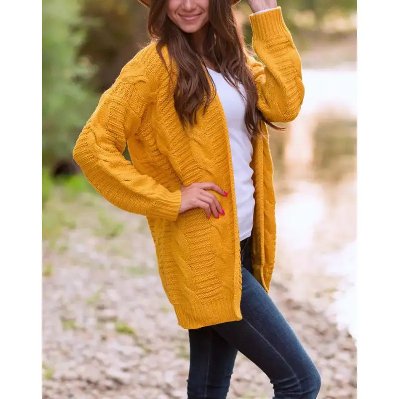 a woman wearing a yellow cardigan sweater