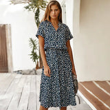 a woman wearing a navy and white floral print dress