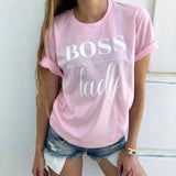 a woman wearing a pink shirt with the words boss on it