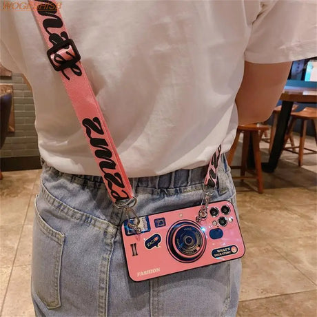 a pink camera bag with a camera strap