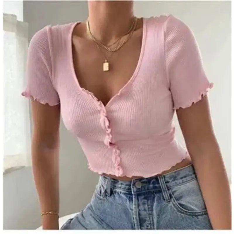 a woman wearing a pink top and jeans