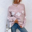 a woman wearing a pink sweater and jeans