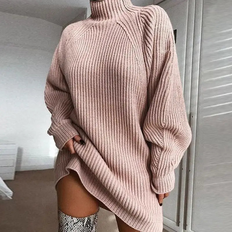 a woman wearing a pink sweater and snakeskin boots