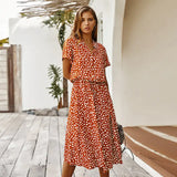 a woman wearing a red polka print dress