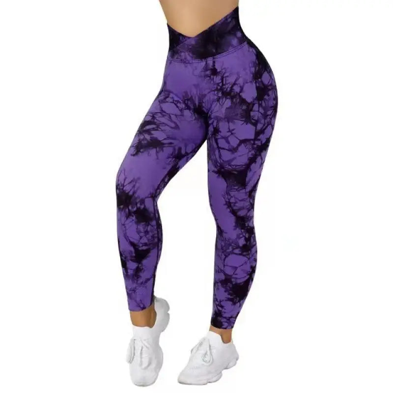 a woman wearing purple and black tie dye leggings