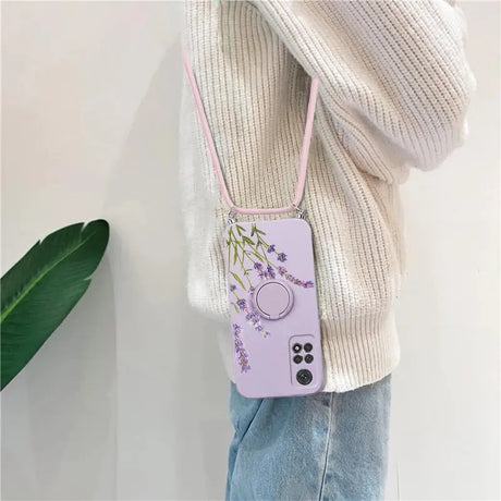 a woman wearing a purple phone case with a purple flower design