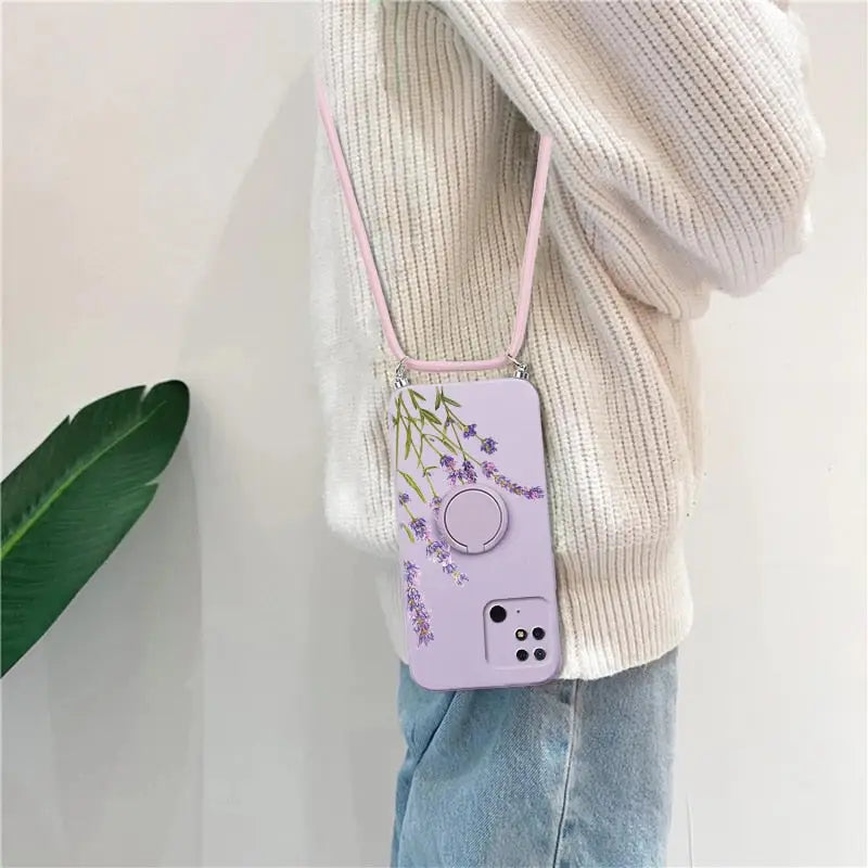 a woman wearing a purple phone case with a purple flower design