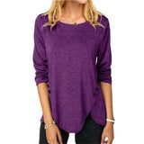 a woman wearing a purple sweater and black jeans