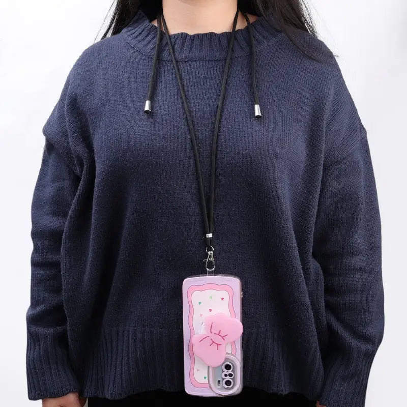 a woman wearing a sweater and holding a cell case