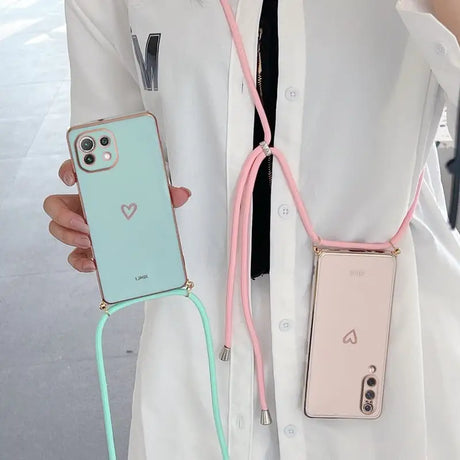 a woman wearing a white coat holding a pink and green phone case