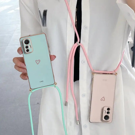 a woman wearing a white coat holding a pink and green phone case