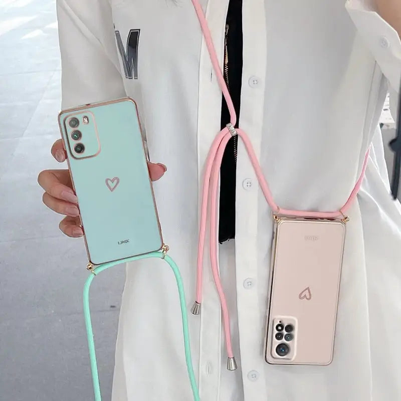 a woman wearing a white coat holding a pink and green phone case