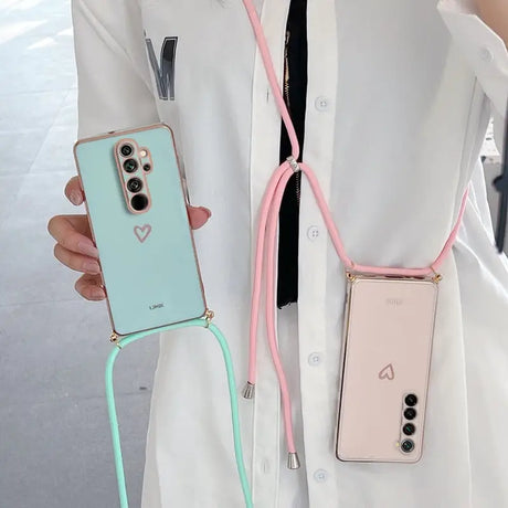 a woman wearing a white coat holding a pink and green phone case