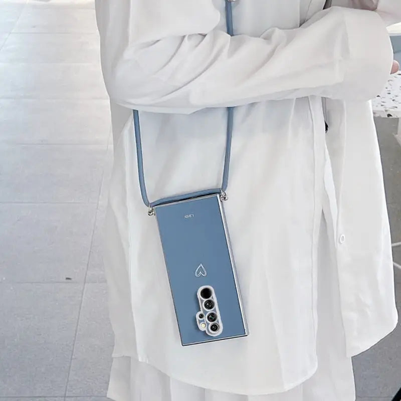 a woman in a white coat holding a blue cell phone