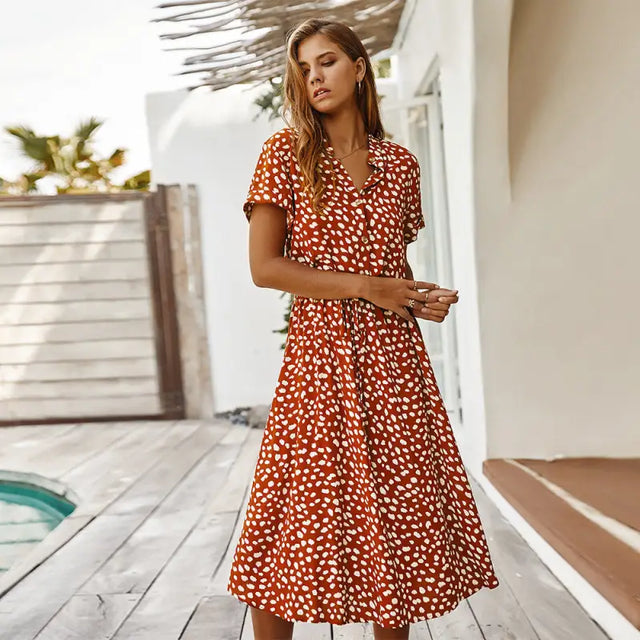 a woman wearing a red and white polka print dress