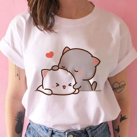 a woman wearing a white t shirt with a cat on it