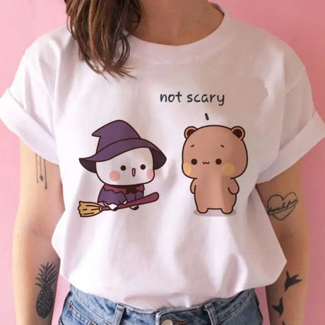 a woman wearing a white shirt with a cartoon bear on it