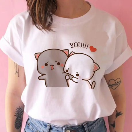 a woman wearing a white shirt with a cartoon cat on it