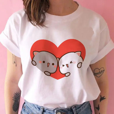 a woman wearing a white t shirt with a red heart on it