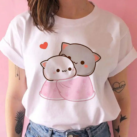 a woman wearing a white t shirt with a pink heart on it