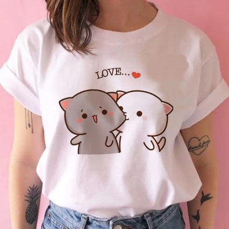 a woman wearing a white shirt with a cartoon cat on it