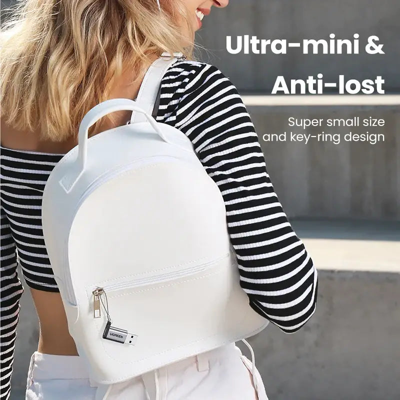 a woman wearing a white backpack with the words,’urban art ’