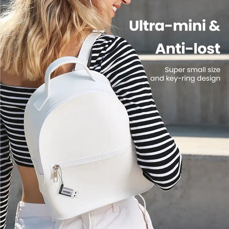 A woman wearing a white backpack with the words,’urban art ’